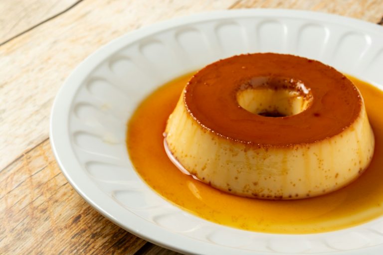 a small dessert on a white plate on a wooden table